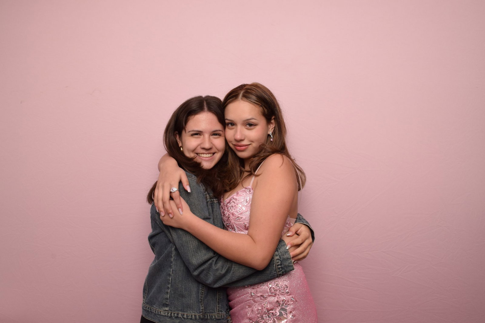 Guests posing against a blush backdrop at a 29PM event
