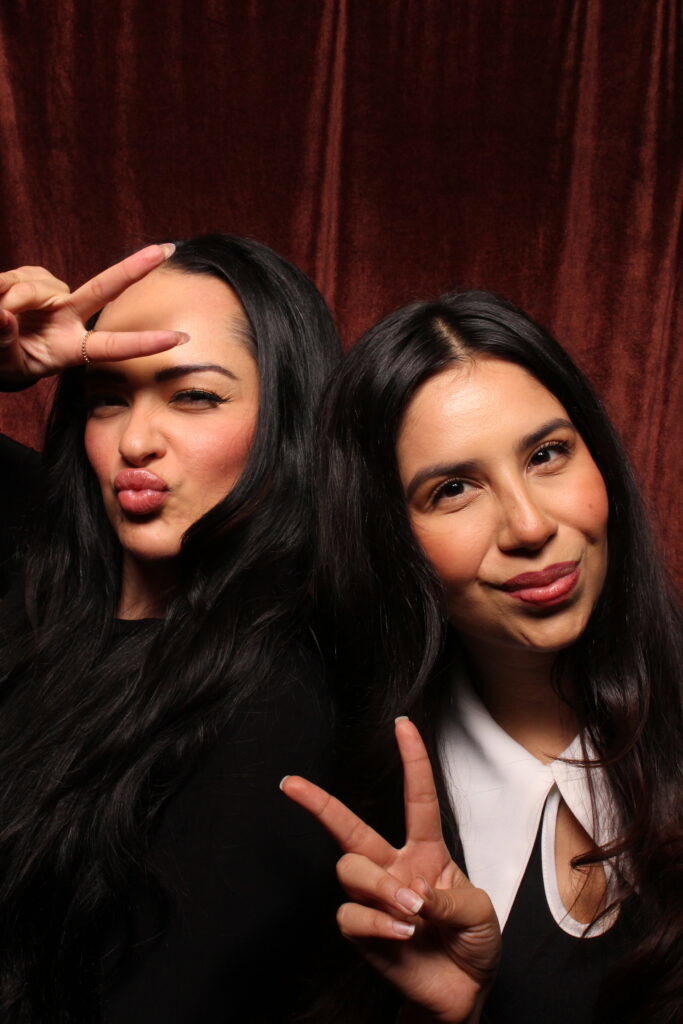 Two guests posing and making peace signs in the 29PM photo booth