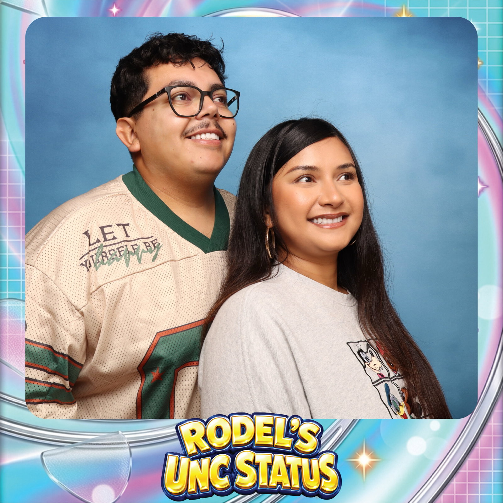 Permata and Melvin posing in a custom Rodel's UNC Status photo booth frame