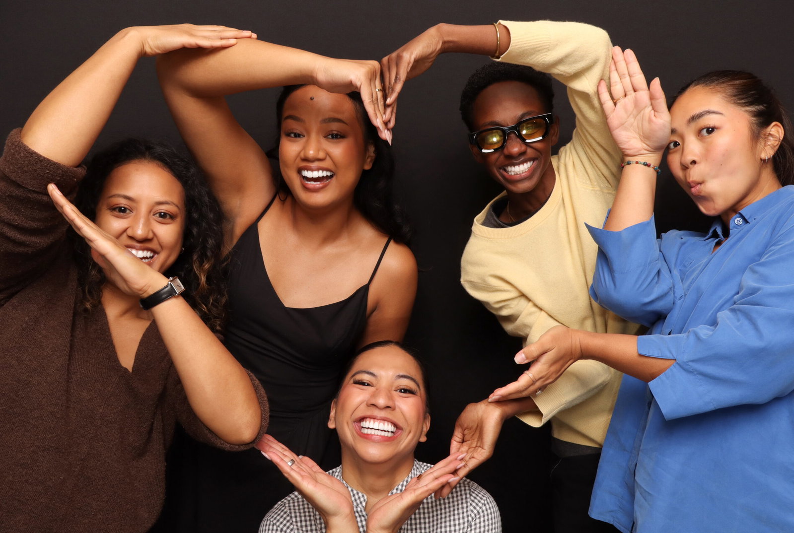Five friends fitting together in a playful 29PM Modern Open-Air photo booth group portrait