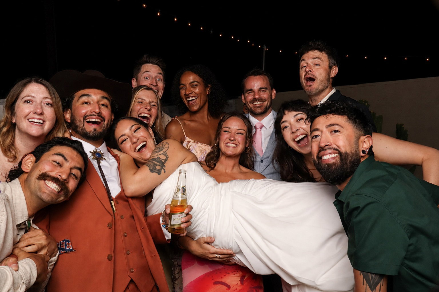Wedding guests gathered for a lively 29PM Modern Open-Air photo booth group portrait