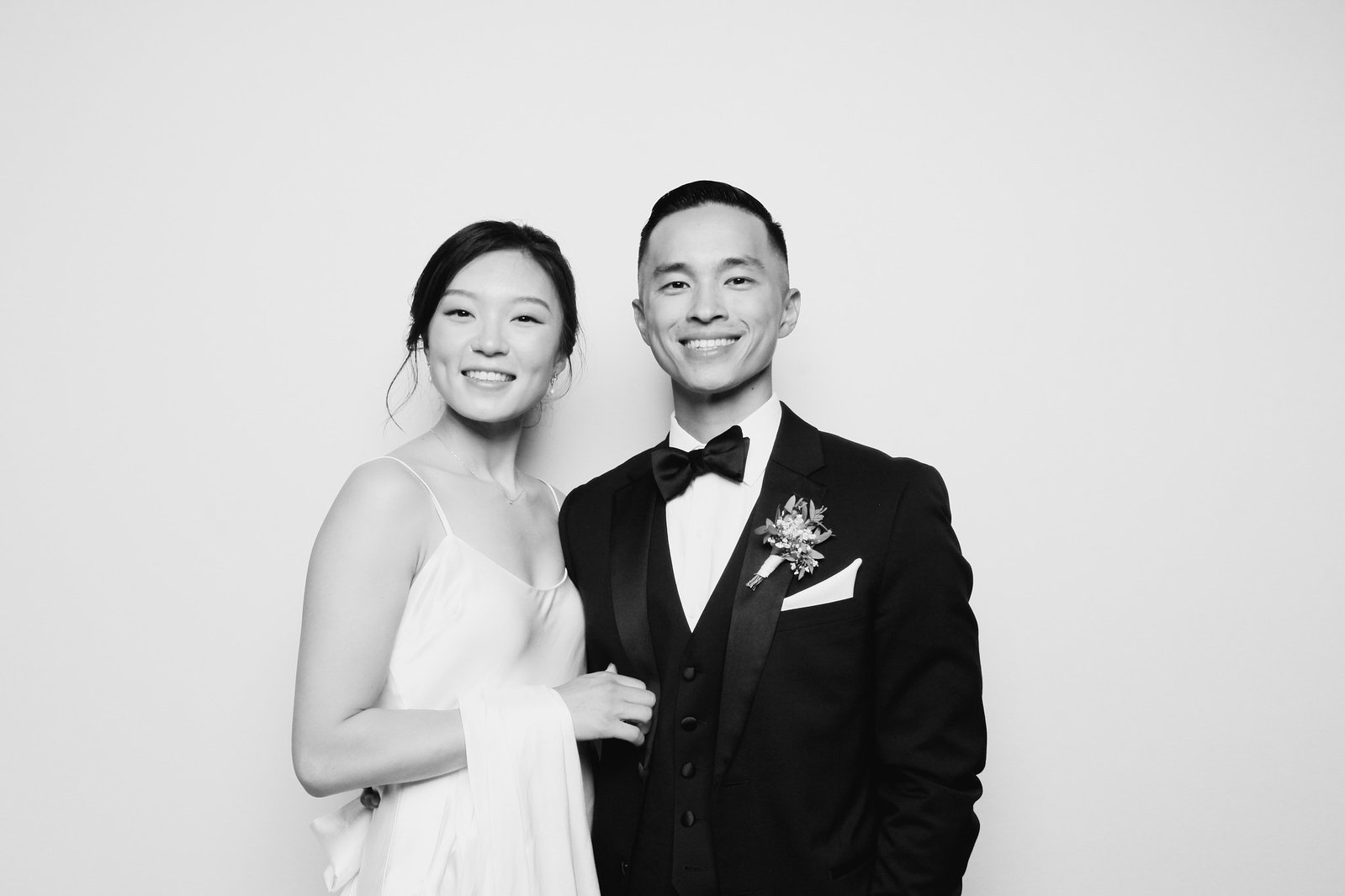 Newlywed couple smiling in a polished black-and-white Glam Booth portrait