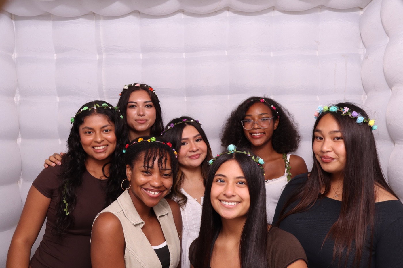 Students wearing flower crowns inside an inflatable photo booth